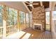 Relaxing screened porch with stone fireplace and wood flooring at 143 Traceway N, Sanford, NC 27332