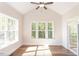 Sunroom boasts hardwood floors, multiple windows, and a ceiling fan at 143 Traceway N, Sanford, NC 27332