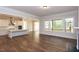 Open kitchen with white cabinets, island, and hardwood floors at 143 Traceway N, Sanford, NC 27332