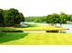 Golf course with lakefront property, offering stunning views and a tranquil atmosphere at 143 Traceway N, Sanford, NC 27332