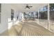 Relaxing screened porch with wooden deck and ceiling fan at 4155 Us-421, Lillington, NC 27546