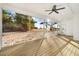 Screened porch overlooking backyard with a ceiling fan at 4155 Us-421, Lillington, NC 27546