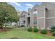 Exterior view of condo building with landscaping and walkway at 3706 Chimney Ridge Pl # 201, Durham, NC 27713