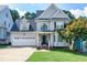 Two-story house with a gray exterior and a white garage door at 1276 Dalgarven Dr, Apex, NC 27502