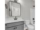 Main bathroom with grey vanity, large mirror, and bathtub at 1516 Nc 55, Coats, NC 27521