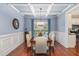 Elegant dining room with coffered ceiling, wainscoting, and wood floors at 2024 Temple Hills Way, Fuquay Varina, NC 27526