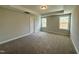 Spacious bedroom with neutral carpeting and two windows offering natural light at 824 Putney Hill Rd, Zebulon, NC 27597