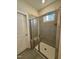 Walk-in shower with gray tile and built-in bench seat at 824 Putney Hill Rd, Zebulon, NC 27597