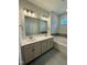 Double vanity bathroom with a soaking tub and modern fixtures at 824 Putney Hill Rd, Zebulon, NC 27597