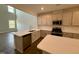 Modern kitchen with white cabinets, large island, and stainless steel appliances at 824 Putney Hill Rd, Zebulon, NC 27597