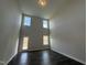 Bright Gathering room with high ceilings, large windows, and hardwood floors at 824 Putney Hill Rd, Zebulon, NC 27597