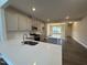 Modern kitchen with white quartz countertops and stainless steel sink at 824 Putney Hill Rd, Zebulon, NC 27597