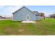 Rear view of house with blue siding and small patio at 306 E Godwin St, Dunn, NC 28334