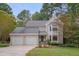 Two-story house with beige siding, a two-car garage and a well-maintained lawn at 6 Placid Ct, Durham, NC 27713