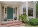 Inviting front entrance with teal door, brick steps, and potted plants at 6 Placid Ct, Durham, NC 27713