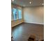 Bright living room featuring dark wood-look flooring and two large windows at 605 Hyperion Aly, Wake Forest, NC 27587