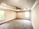 Spacious bedroom with ceiling fan, carpet, and large windows at 211 Hopewell Branch Ct, Smithfield, NC 27577