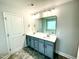 Double vanity bathroom with gray cabinets and a large mirror at 211 Hopewell Branch Ct, Smithfield, NC 27577