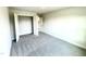 Simple bedroom with grey carpet, a closet, and access to another room at 211 Hopewell Branch Ct, Smithfield, NC 27577