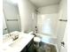 Clean bathroom with a bathtub, toilet, sink, and dark vanity at 211 Hopewell Branch Ct, Smithfield, NC 27577