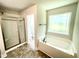 Bathroom features a soaking tub, walk-in shower, and tile flooring at 211 Hopewell Branch Ct, Smithfield, NC 27577