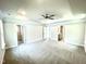 Main bedroom with ceiling fan, carpet, and access to bathroom and closet at 211 Hopewell Branch Ct, Smithfield, NC 27577