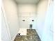 Laundry room with vinyl flooring, shelving, and drain at 211 Hopewell Branch Ct, Smithfield, NC 27577