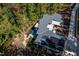 Home with solar panels and a pool, surrounded by trees at 23930 Cherry, Chapel Hill, NC 27517