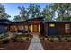 Modern home exterior with a lighted walkway and landscaping at 23930 Cherry, Chapel Hill, NC 27517