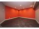 Finished basement room with red walls and dark wood-look flooring at 23930 Cherry, Chapel Hill, NC 27517