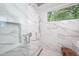 Elegant shower with marble walls, a frameless glass enclosure, and modern fixtures at 23930 Cherry, Chapel Hill, NC 27517