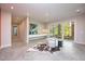 Open basement sitting area with concrete floors, a large piece of art, and sliding glass doors leading to a patio at 23930 Cherry, Chapel Hill, NC 27517