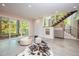 Spacious basement recreation room with concrete floors, modern furniture, and sliding glass doors leading to a patio at 23930 Cherry, Chapel Hill, NC 27517