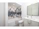 Modern bathroom with a white vanity, black and white tile shower, and a bathtub at 23930 Cherry, Chapel Hill, NC 27517