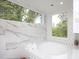 Luxurious bathroom with a large soaking tub, marble tile, and a spacious shower at 23930 Cherry, Chapel Hill, NC 27517