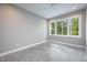 Bright bedroom with large window and concrete floor at 23930 Cherry, Chapel Hill, NC 27517