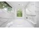 Spa-like bathroom featuring a free-standing tub, marble finishes, and abundant natural light at 23930 Cherry, Chapel Hill, NC 27517