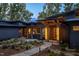 Modern home exterior with a lighted walkway and landscaping at 23930 Cherry, Chapel Hill, NC 27517