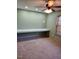 Home office with built-in desk and ceiling fan at 95 Crownside Dr, Four Oaks, NC 27524