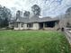 Spacious backyard with grassy lawn and retaining wall at 22005 Turner, Chapel Hill, NC 27517