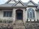 Stone facade with an arched entryway and a staircase at 22005 Turner, Chapel Hill, NC 27517