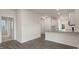 Modern kitchen with white cabinets, granite counters, and stainless steel appliances at 1309 White Verona Way, Knightdale, NC 27545