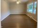 Spacious living room with hardwood floors and large window at 3407 S Mebane St, Burlington, NC 27215
