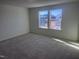 Bedroom with gray carpet and two windows overlooking the backyard at 2705 Princess Tree Dr, Raleigh, NC 27616