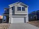 Two-story house with gray siding, white garage door, and landscaping at 2705 Princess Tree Dr, Raleigh, NC 27616
