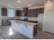 Modern kitchen with dark brown cabinets, quartz countertops, and an island at 2705 Princess Tree Dr, Raleigh, NC 27616