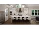 Modern kitchen with white cabinets, large island, and high ceilings at 9417 Rawson Ave, Raleigh, NC 27613