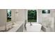 Luxurious bathroom with marble finishes and a large soaking tub at 9417 Rawson Ave, Raleigh, NC 27613