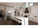 Modern kitchen with white cabinets, large island, and high ceilings at 9417 Rawson Ave, Raleigh, NC 27613