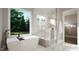 Spa-like bathroom with marble shower and soaking tub at 9417 Rawson Ave, Raleigh, NC 27613